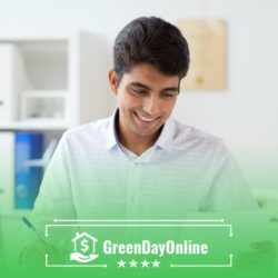 A man sitting in front of a laptop computer reading about the risks of falling into a payday loan debt cycle