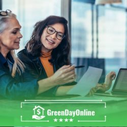 Two women sitting at a table appllying for a payday loan with a cosigner through a tablet