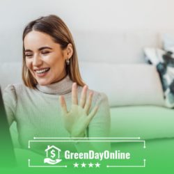 A woman holding a tablet in front of a couch filling out a payday loan form