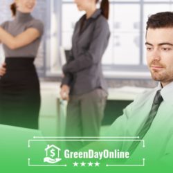 A man in a tie standing in front of a laptop inspecting payday loans in Jacksonville