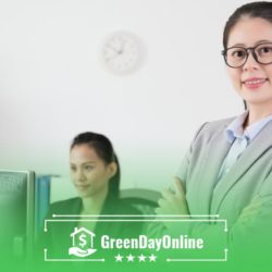 A woman standing in front of a computer monitor analyzing payday loans in San Francisco